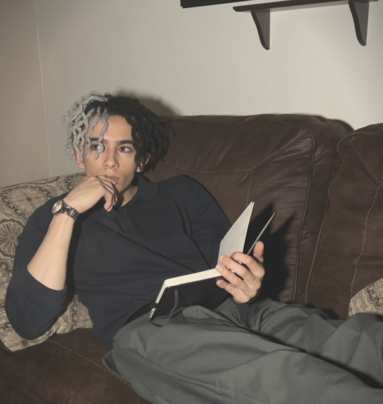 Caesar Martinez, founder and CEO of Nocthea Industries, seated with an open notebook.